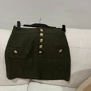 Green mini skirt with gold buttons